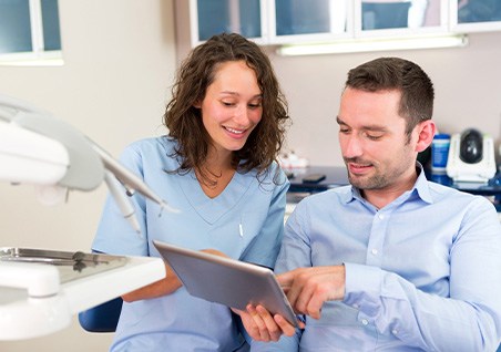A dentist in Bellaire reviewing teeth whitening options with a patient 