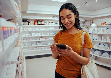 Patient at pharmacy looking at teeth whitening products