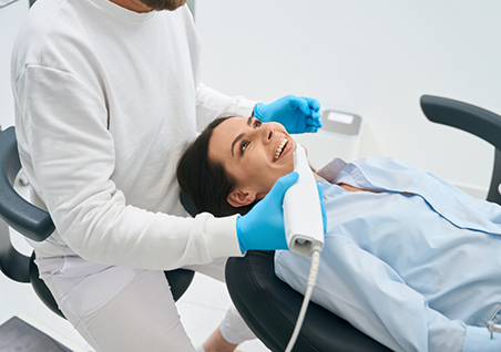 Dental patient having her mouth scanned by her dentist