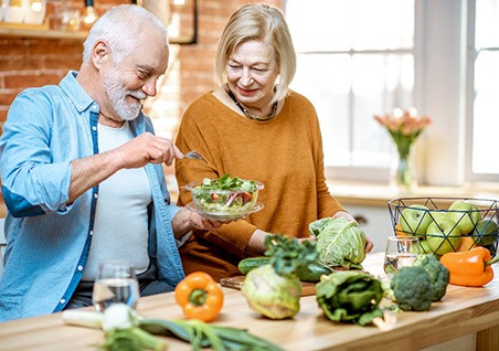 Bellaire patient enjoying a healthy meal with dentures 