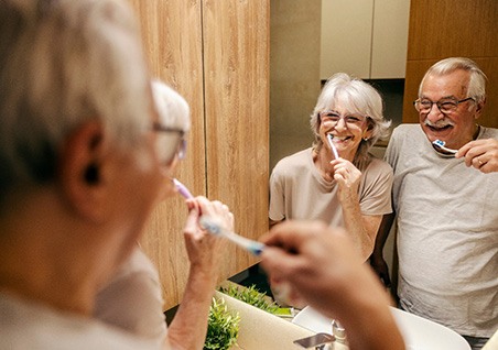 Bellaire patient brushing with partner in mirror