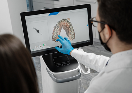 Dentist showing a patient a digital impression of a row of their teeth
