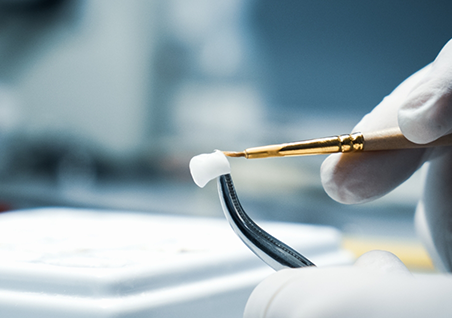 Ceramist crafting a dental crown
