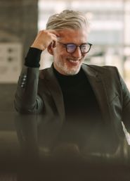 Smiling older man in a dark gray suit