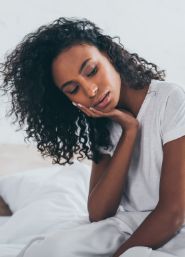 Woman holding the side of her cheek in pain