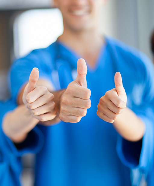 Three Bellaire dental team members giving thumbs up