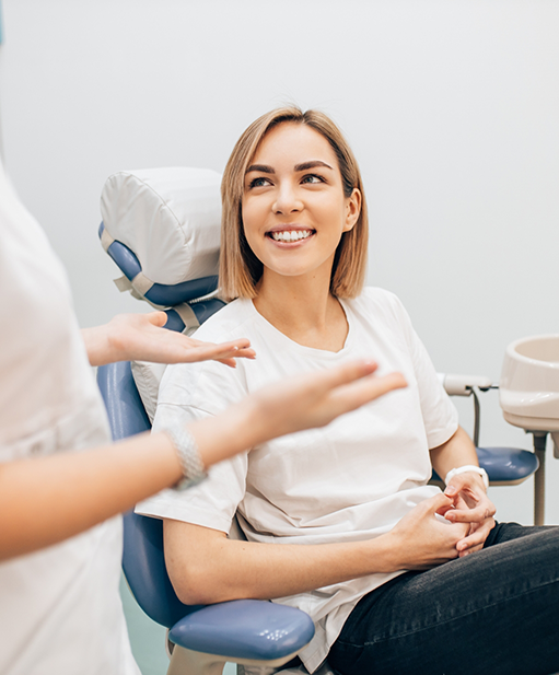 Woman listening to her dentist talk about dental services in Bellaire