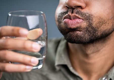A man gargling water after scaling and root planing