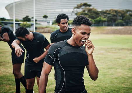Man putting on mouthguard
