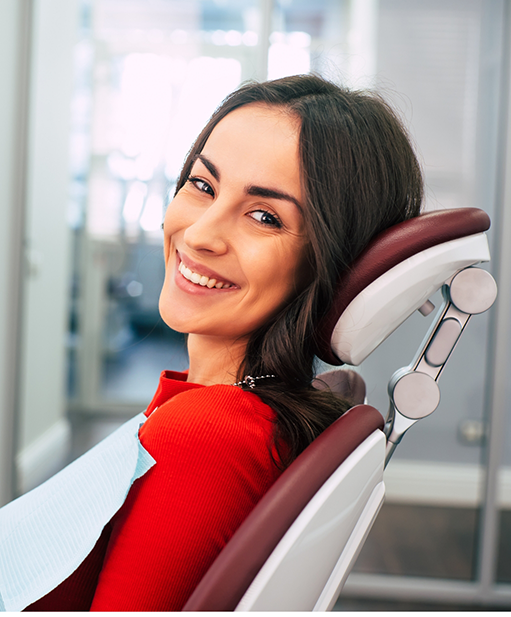 Woman in dental chair smiling at a preventive dentistry checkup in Bellaire