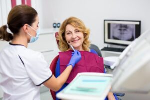 Woman smiling after getting dentures